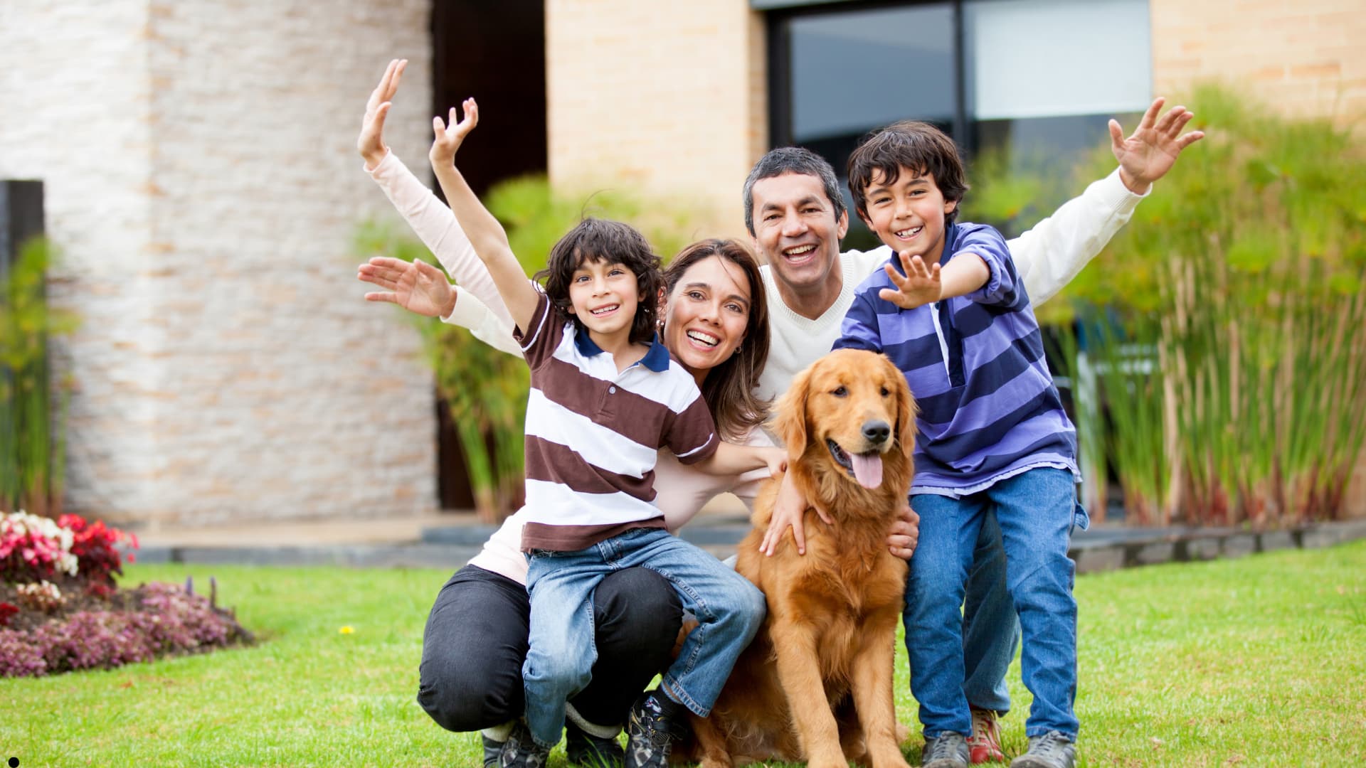 Family having fun in yard with dog