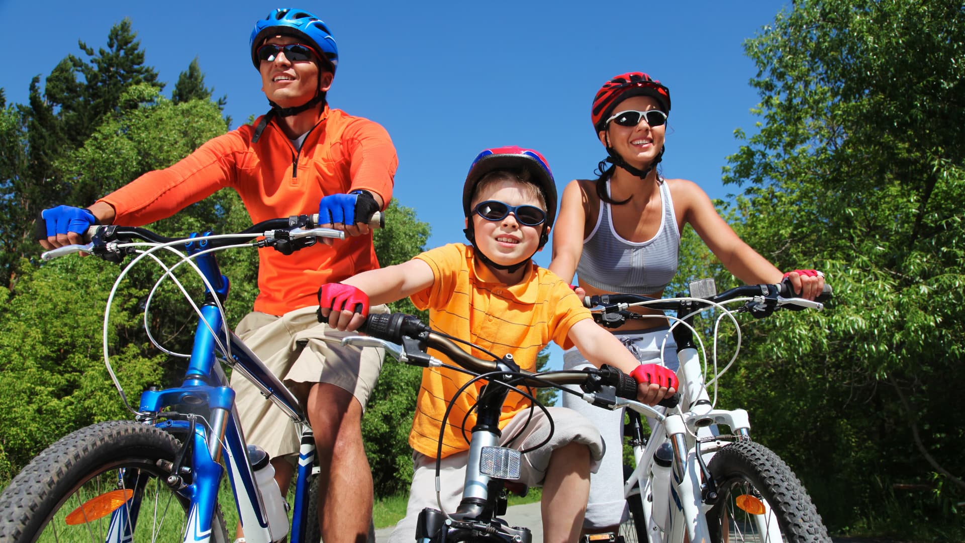 Family riding bikes in a park